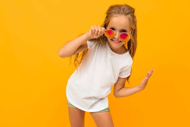 Portrait of handsome caucasian girl with long chestnut hair, sunglasses, pretty face and fit body rejoices